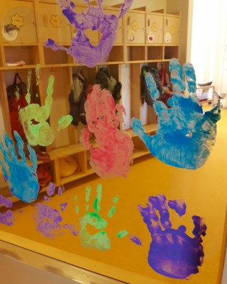 Kuva: Lasten kädenjälkiä maalattuna ikkunaan.